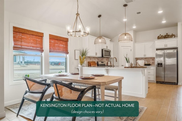 24119 Western Ave, Washington, OK 73093 - kitchen with stainless steel appliances, backsplash, white cabinetry, pendant lighting, and a chandelier