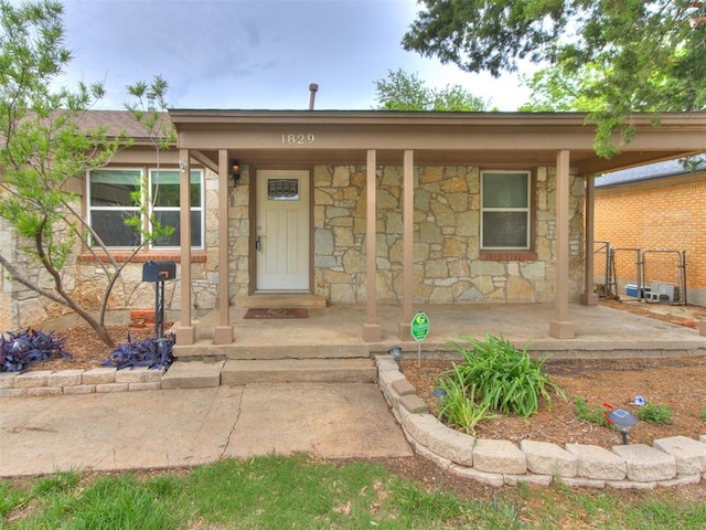 1829 Westchester Dr, Oklahoma City, OK 73120 - view of front of property with stone siding and a porch