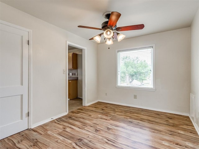 1829 Westchester Dr, Oklahoma City, OK 73120 - unfurnished bedroom with light wood-type flooring, baseboards, and ceiling fan