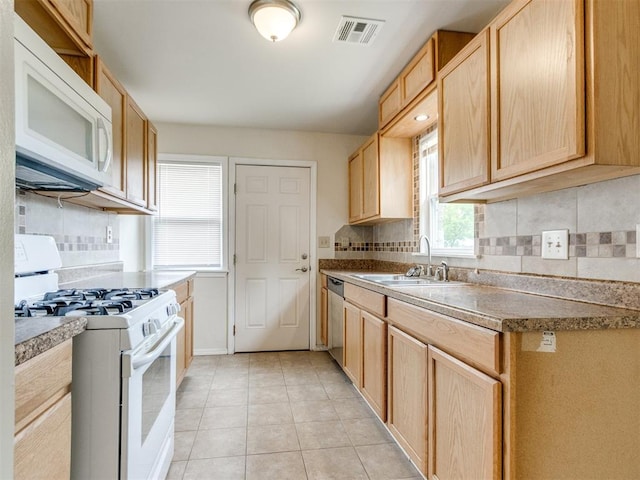 1829 Westchester Dr, Oklahoma City, OK 73120 - kitchen with white appliances, a sink, backsplash, light tile patterned flooring, and light brown cabinetry