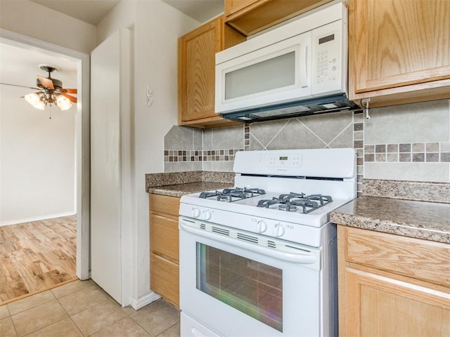 1829 Westchester Dr, Oklahoma City, OK 73120 - kitchen featuring white appliances, backsplash, light tile patterned floors, ceiling fan, and baseboards