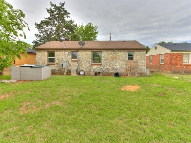 1829 Westchester Dr, Oklahoma City, OK 73120 - back of property featuring stone siding, a pool, and central AC unit