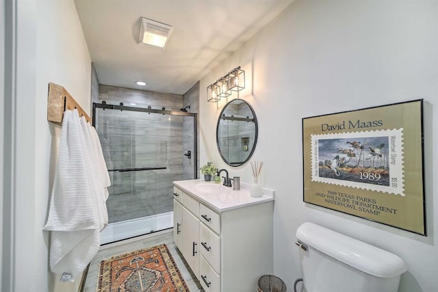 519 N J St, Eufaula, OK 74432 - bathroom with a shower stall, vanity, toilet, and wood finished floors