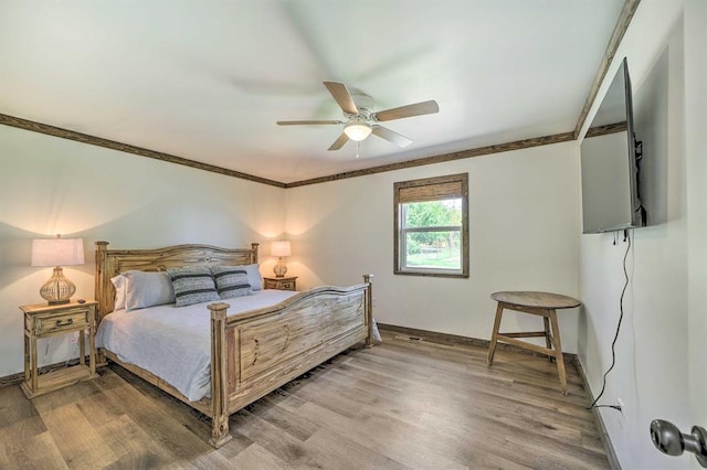 519 N J St, Eufaula, OK 74432 - bedroom with ornamental molding, light wood-style flooring, baseboards, and a ceiling fan