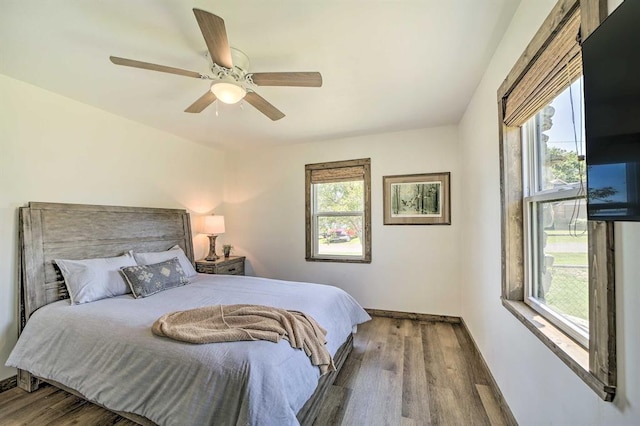 519 N J St, Eufaula, OK 74432 - bedroom with wood finished floors, baseboards, and a ceiling fan