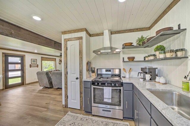 519 N J St, Eufaula, OK 74432 - kitchen with stainless steel range with gas stovetop, wall chimney range hood, gray cabinets, open shelves, and ornamental molding