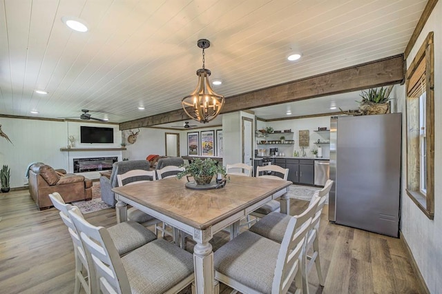 519 N J St, Eufaula, OK 74432 - dining area featuring wooden ceiling, a chandelier, light wood-style floors, a glass covered fireplace, and recessed lighting