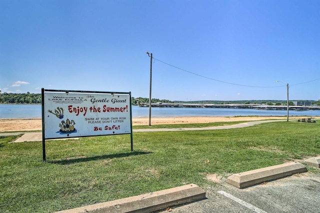 519 N J St, Eufaula, OK 74432 - surrounding community with a yard, a water view, and uncovered parking