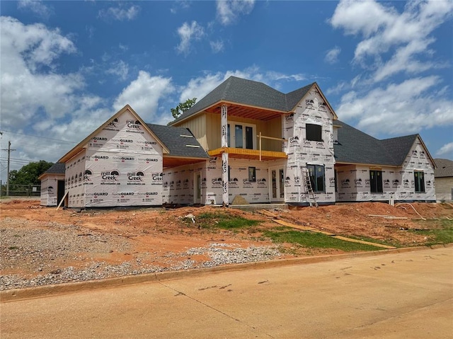 6201 Canopy Ln, Edmond, OK 73025 - property in mid-construction with a balcony and board and batten siding