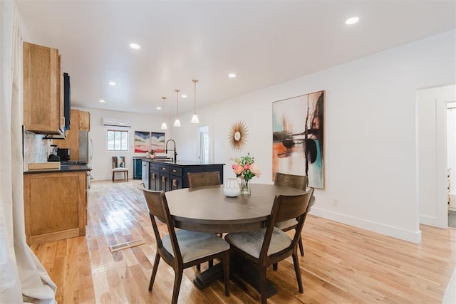 221 Alameda St, Norman, OK 73069 - dining space with light wood-type flooring, baseboards, recessed lighting, and a wall mounted air conditioner