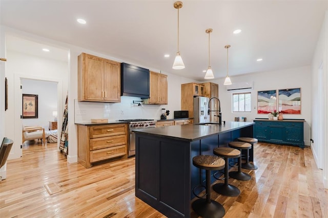 221 Alameda St, Norman, OK 73069 - kitchen with dark countertops, a sink, stainless steel appliances, light wood-type flooring, and a breakfast bar