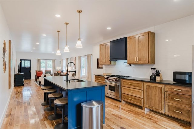 221 Alameda St, Norman, OK 73069 - kitchen with a sink, high end range, light wood-type flooring, dark countertops, and black microwave