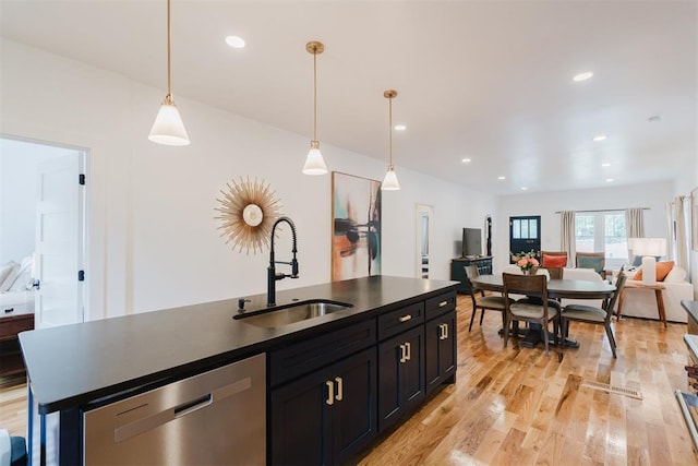 221 Alameda St, Norman, OK 73069 - kitchen featuring dishwasher, a sink, open floor plan, light wood finished floors, and dark cabinets