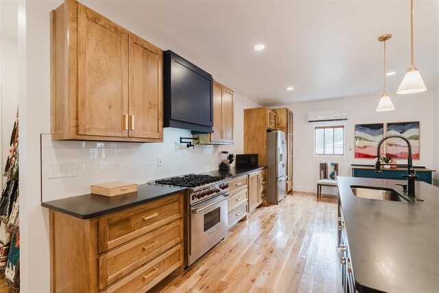 221 Alameda St, Norman, OK 73069 - kitchen with appliances with stainless steel finishes, a sink, dark countertops, light wood finished floors, and tasteful backsplash