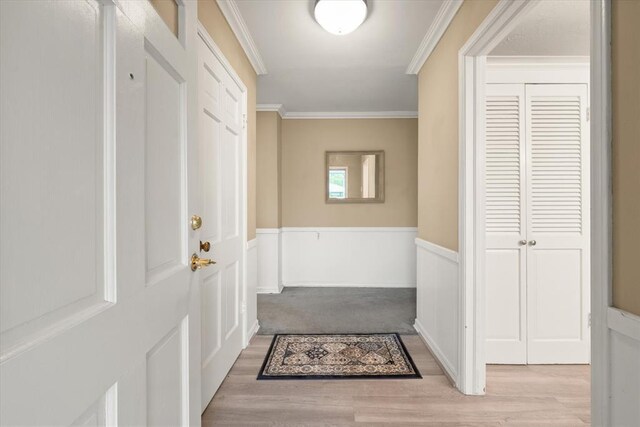 3222 Wilshire Ter, Oklahoma City, OK 73116 - doorway featuring ornamental molding, wood finished floors, and wainscoting