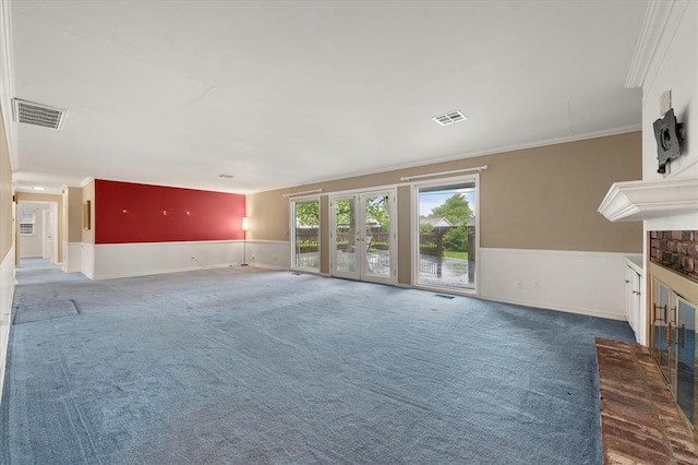 3222 Wilshire Ter, Oklahoma City, OK 73116 - unfurnished living room featuring crown molding, carpet flooring, a wainscoted wall, french doors, and a fireplace