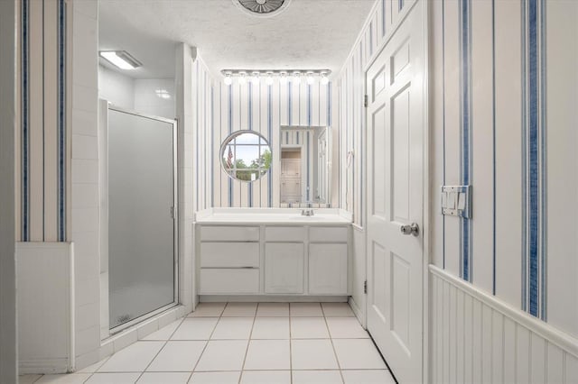 3222 Wilshire Ter, Oklahoma City, OK 73116 - full bath with a stall shower, a textured ceiling, vanity, and tile patterned floors