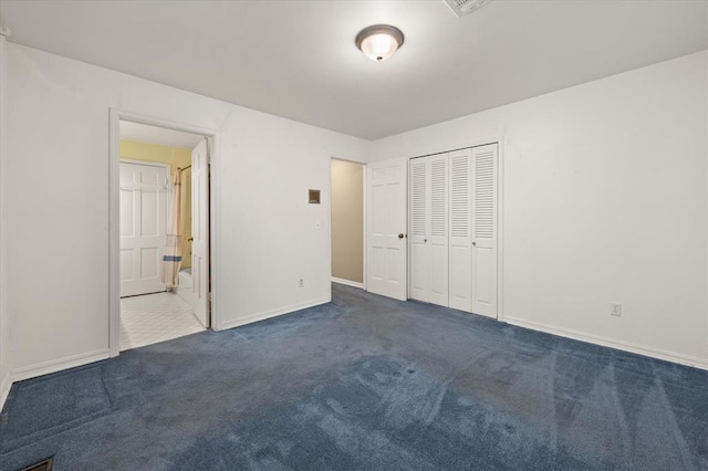 3222 Wilshire Ter, Oklahoma City, OK 73116 - unfurnished bedroom featuring dark carpet, baseboards, a closet, and connected bathroom