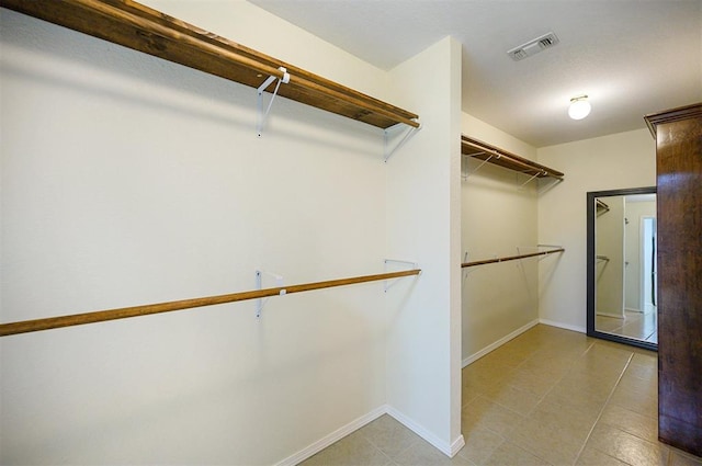 spacious closet featuring light tile patterned floors