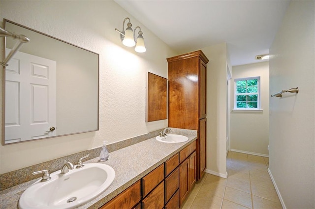 full bathroom featuring tile patterned floors, double vanity, and baseboards