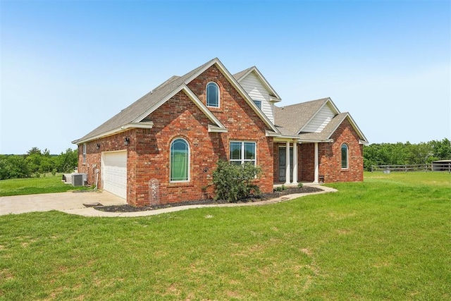 18421 State Highway 24, Purcell, OK 73080 - traditional-style house featuring central AC, brick siding, concrete driveway, a shingled roof, and an attached garage
