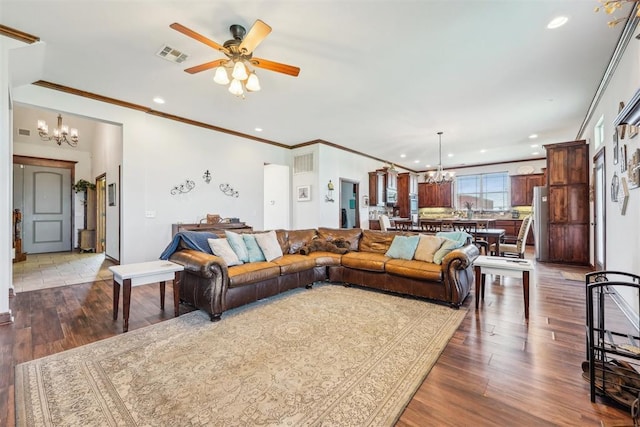 18421 State Highway 24, Purcell, OK 73080 - living area featuring a chandelier, ceiling fan, wood finished floors, recessed lighting, and crown molding