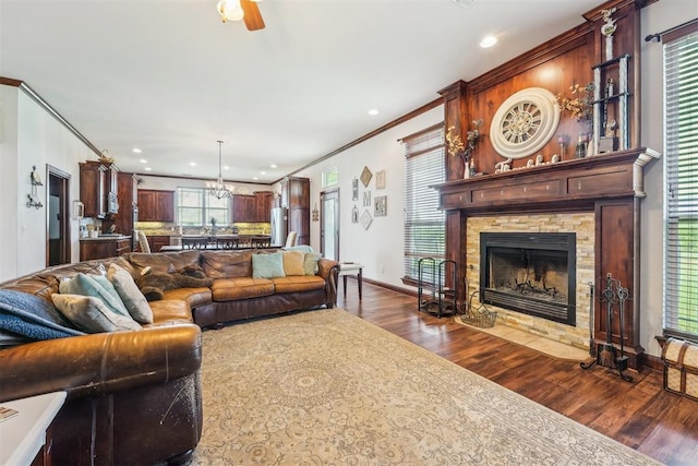18421 State Highway 24, Purcell, OK 73080 - living area with dark wood finished floors, crown molding, recessed lighting, a ceiling fan, and a stone fireplace