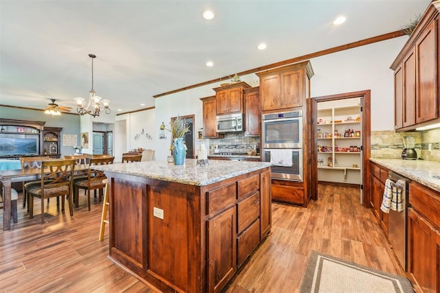 18421 State Highway 24, Purcell, OK 73080 - kitchen with stainless steel appliances, tasteful backsplash, crown molding, a center island, and a chandelier