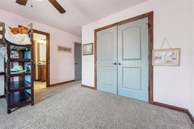 18421 State Highway 24, Purcell, OK 73080 - unfurnished bedroom with light carpet, a closet, baseboards, a ceiling fan, and ensuite bathroom
