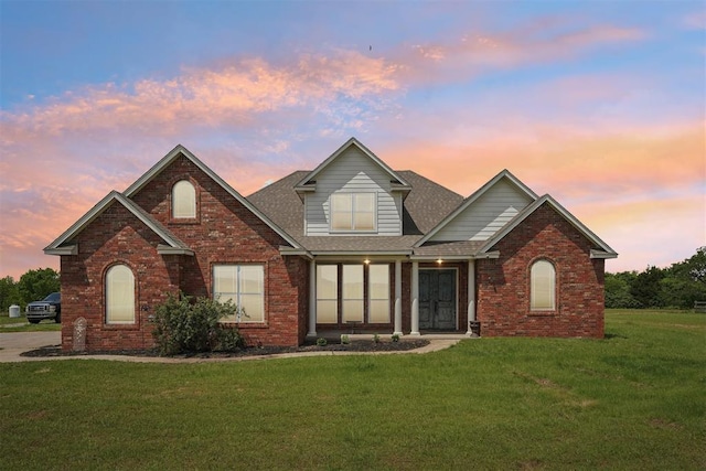 18421 State Highway 24, Purcell, OK 73080 - traditional-style home with brick siding, a lawn, and a shingled roof