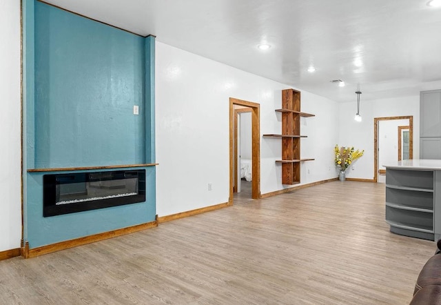 502 W Pine St, Tuttle, OK 73089 - unfurnished living room with light wood-style flooring, baseboards, and recessed lighting