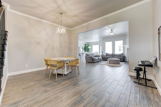 18337 Tombstone Trl, Norman, OK 73072 - dining room with wood finished floors, crown molding, baseboards, a chandelier, and a ceiling fan