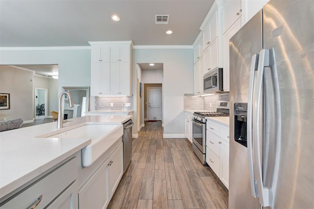 18337 Tombstone Trl, Norman, OK 73072 - kitchen with stainless steel appliances, a sink, light countertops, decorative backsplash, and recessed lighting