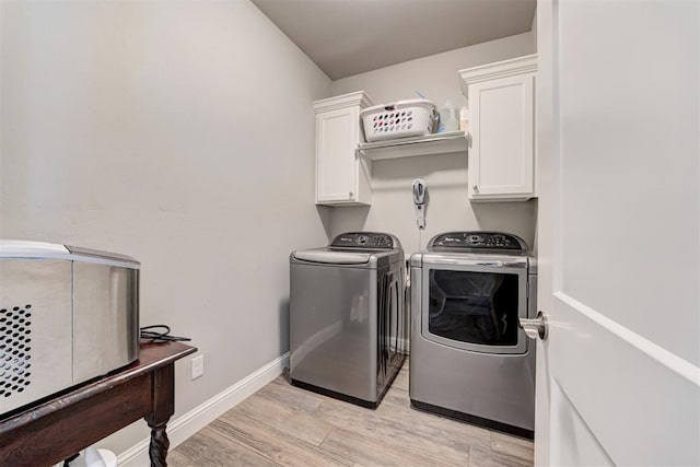 18337 Tombstone Trl, Norman, OK 73072 - laundry room featuring washing machine and dryer, cabinet space, light wood-type flooring, and baseboards