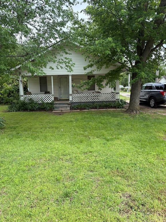 view of front of home with a porch and a front yard