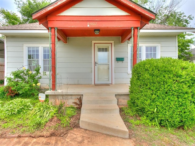 3617 N Westmont St, Oklahoma City, OK 73118 - doorway to property featuring a shingled roof and covered porch