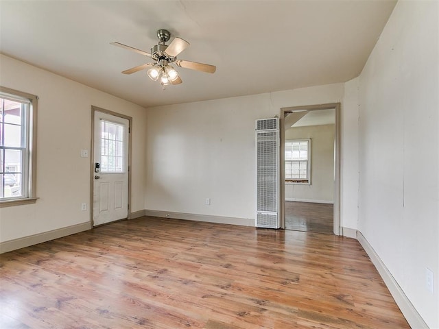 3617 N Westmont St, Oklahoma City, OK 73118 - empty room with a heating unit, healthy amount of natural light, light wood-style floors, and a ceiling fan