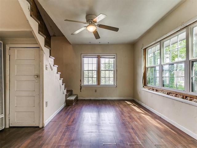 3617 N Westmont St, Oklahoma City, OK 73118 - empty room featuring dark wood-type flooring, stairs, baseboards, and a ceiling fan