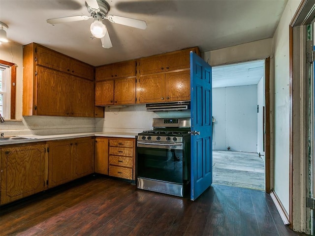 3617 N Westmont St, Oklahoma City, OK 73118 - kitchen with stainless steel gas range, brown cabinetry, dark wood-type flooring, light countertops, and ventilation hood