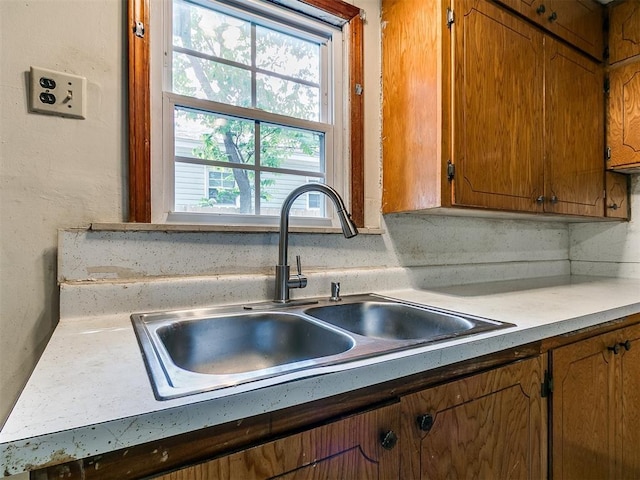 3617 N Westmont St, Oklahoma City, OK 73118 - kitchen with a sink, brown cabinetry, and light countertops