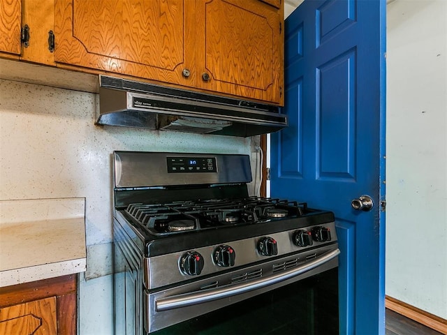 3617 N Westmont St, Oklahoma City, OK 73118 - kitchen with stainless steel gas stove, under cabinet range hood, and brown cabinets