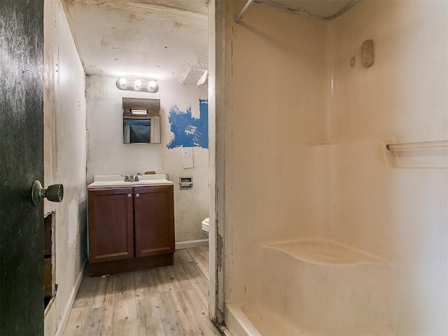 3617 N Westmont St, Oklahoma City, OK 73118 - full bathroom with wood finished floors, toilet, vanity, and a shower