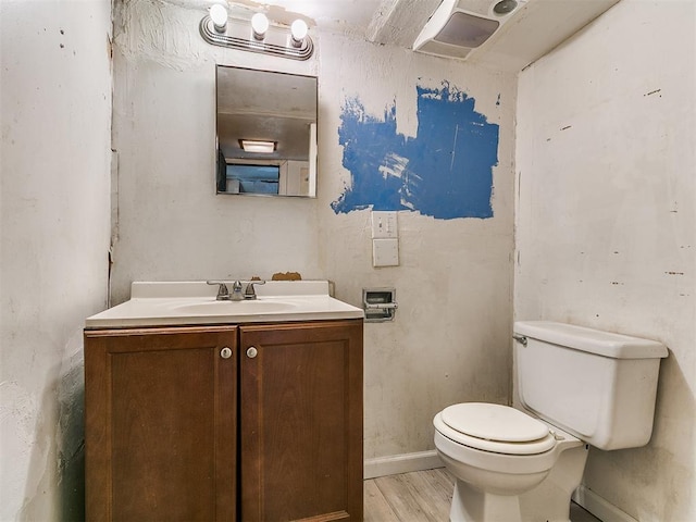 3617 N Westmont St, Oklahoma City, OK 73118 - half bathroom with toilet, vanity, wood finished floors, and baseboards