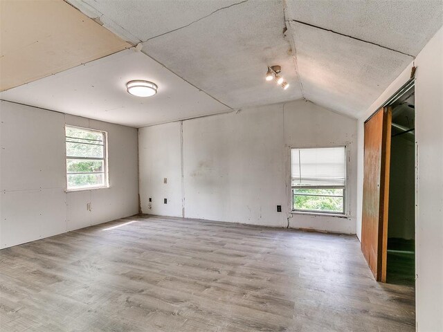 3617 N Westmont St, Oklahoma City, OK 73118 - unfurnished room featuring light wood-style floors and vaulted ceiling