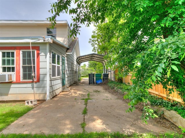 3617 N Westmont St, Oklahoma City, OK 73118 - view of side of property with a detached carport, a gate, and fence