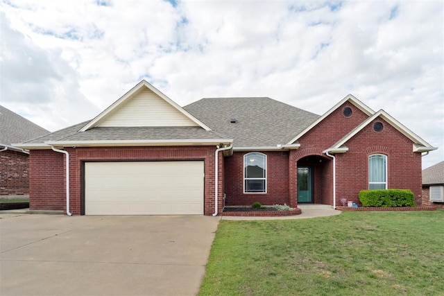 11423 Village Ave, Midwest City, OK 73130 - view of front of house with brick siding, roof with shingles, and an attached garage