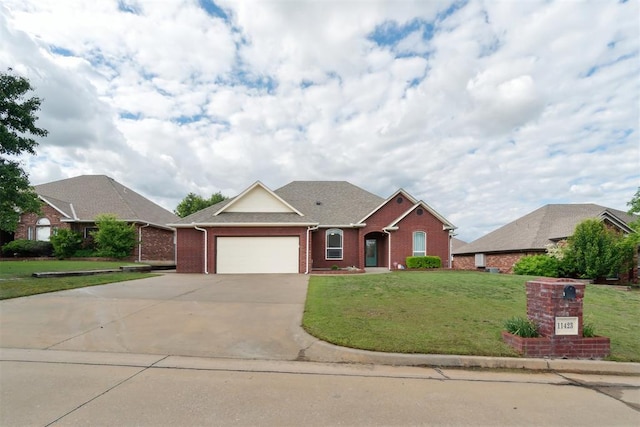11423 Village Ave, Midwest City, OK 73130 - ranch-style home with brick siding, a front lawn, concrete driveway, and a garage