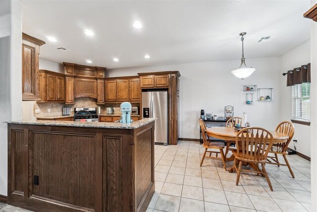 11423 Village Ave, Midwest City, OK 73130 - kitchen featuring stainless steel appliances, decorative backsplash, a peninsula, baseboards, and light stone counters