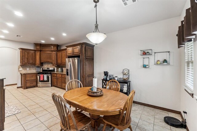 11423 Village Ave, Midwest City, OK 73130 - dining area with light tile patterned flooring, recessed lighting, baseboards, and arched walkways