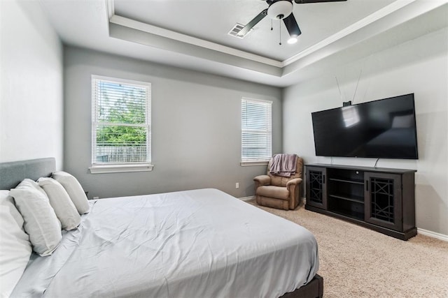11423 Village Ave, Midwest City, OK 73130 - carpeted bedroom with multiple windows, a raised ceiling, baseboards, ornamental molding, and a ceiling fan